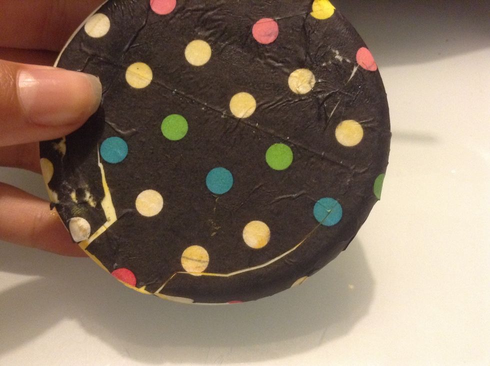 Carefully place the tissue paper on the box and smooth out if needed. If the paper covers the small opening it doesn't matter.