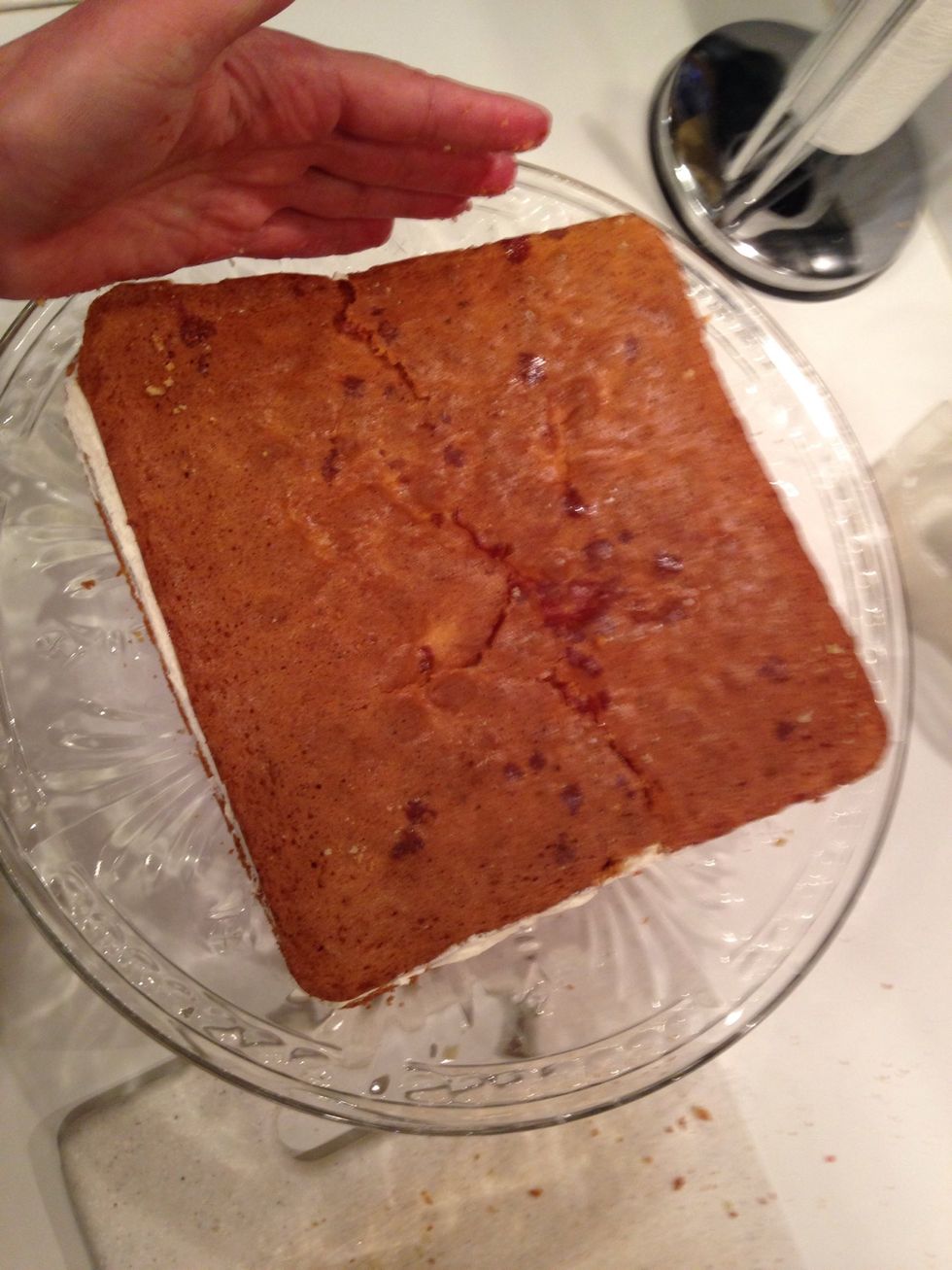 Carefully place the top layer of cake onto the layer of buttercream.