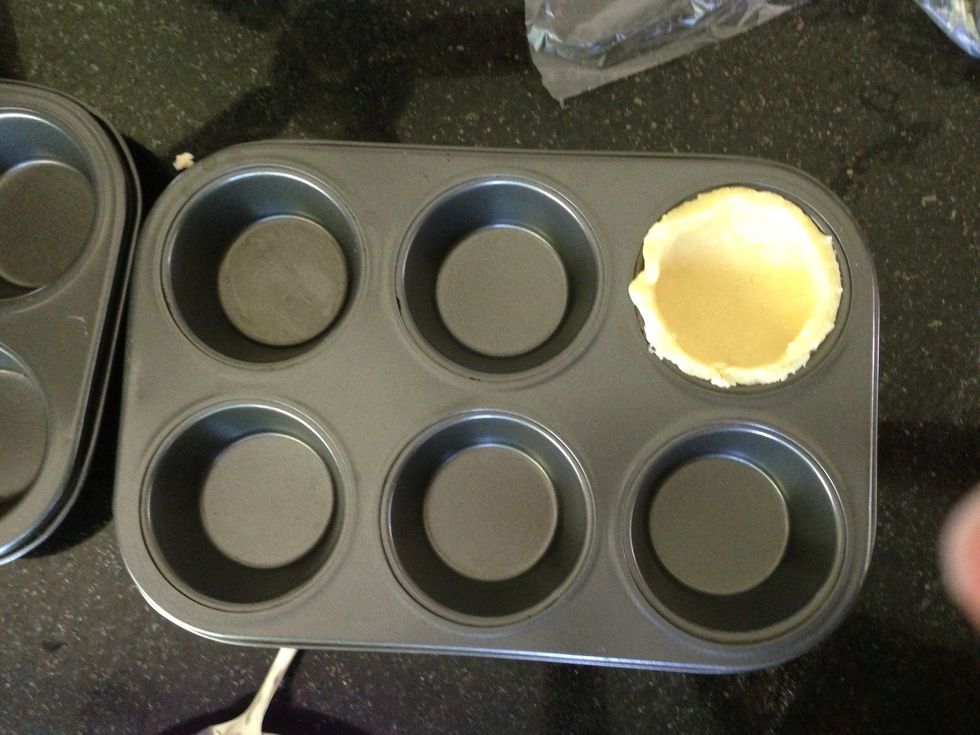 Carefully place your cut dough in the muffin tray (the pastry's buttery enough that I didn't have to grease it, but feel free). Repeat until all batter is used up. I used exactly 12 muffin holes!