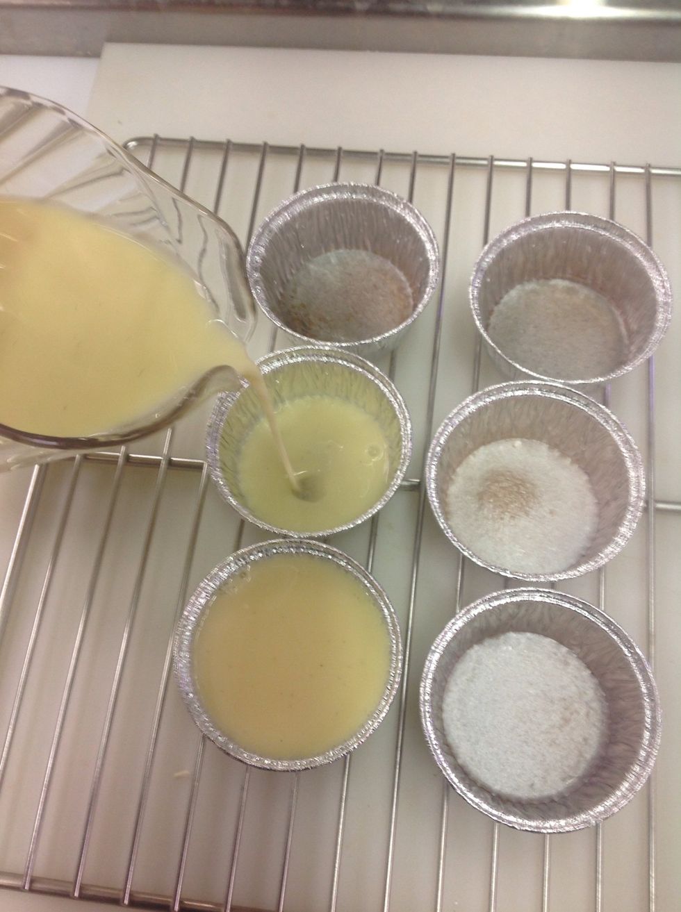 Carefully pour custard into cooled caramelized sugar. If you add it while sugar is still hot, you will scramble your eggs!
