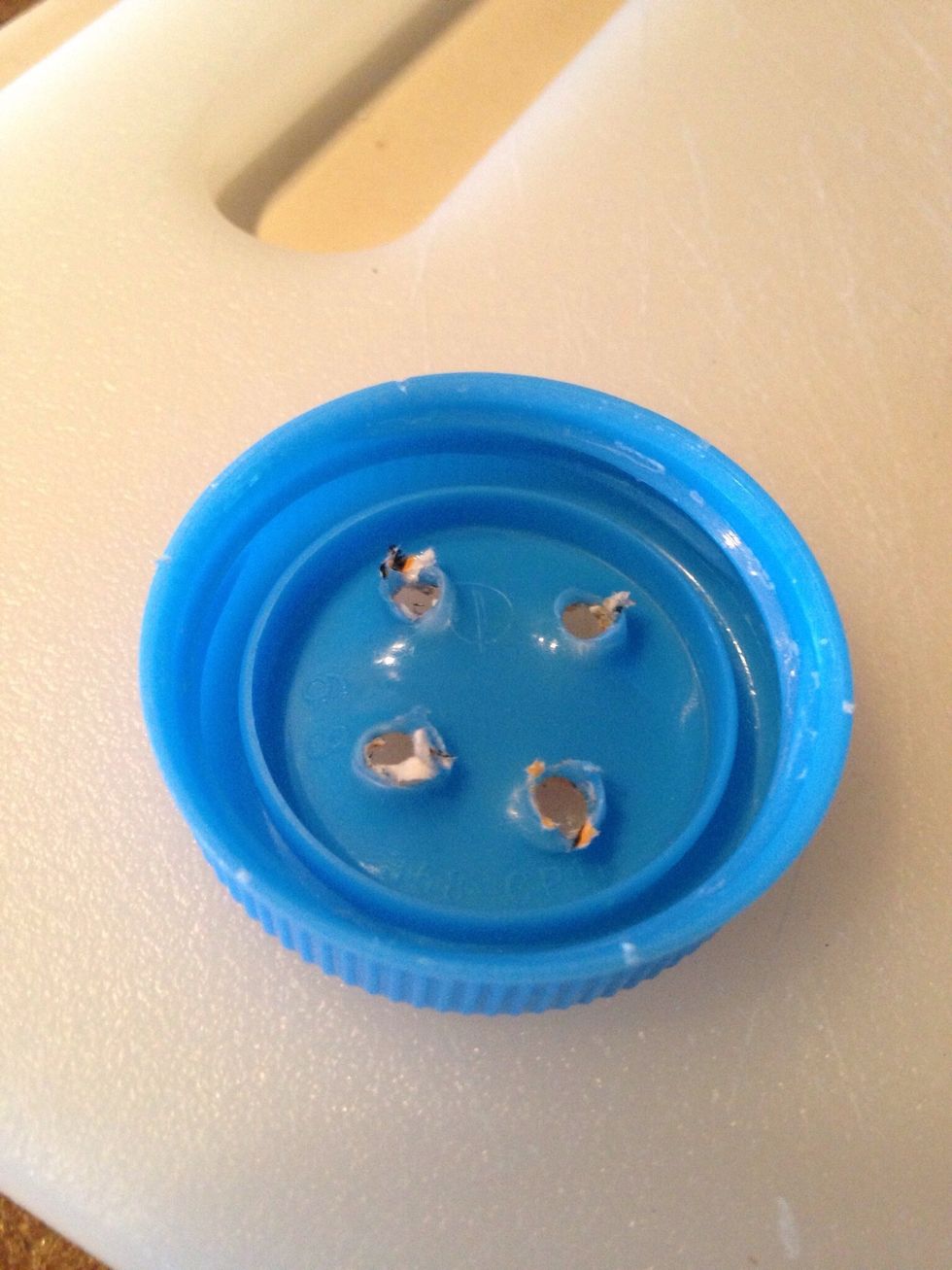 Carefully punch holes in cap with hammer & nail.