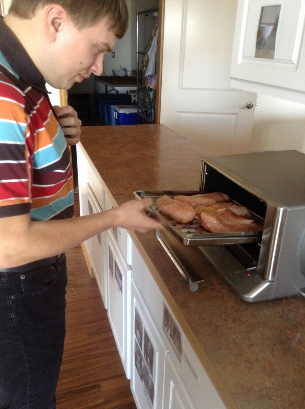 Carefully put chicken in oven