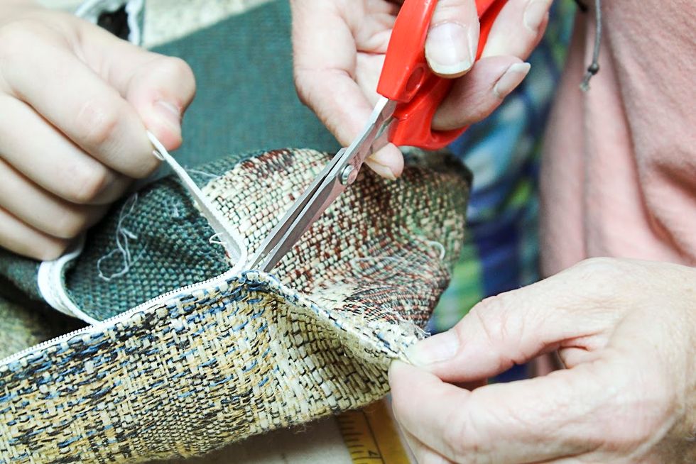 Carefully remove the zipper.  Really sharp, pointy scissors is the key.  And also having an extra hand or two helps with this step to keep it pulled tight while snipping the stitches
