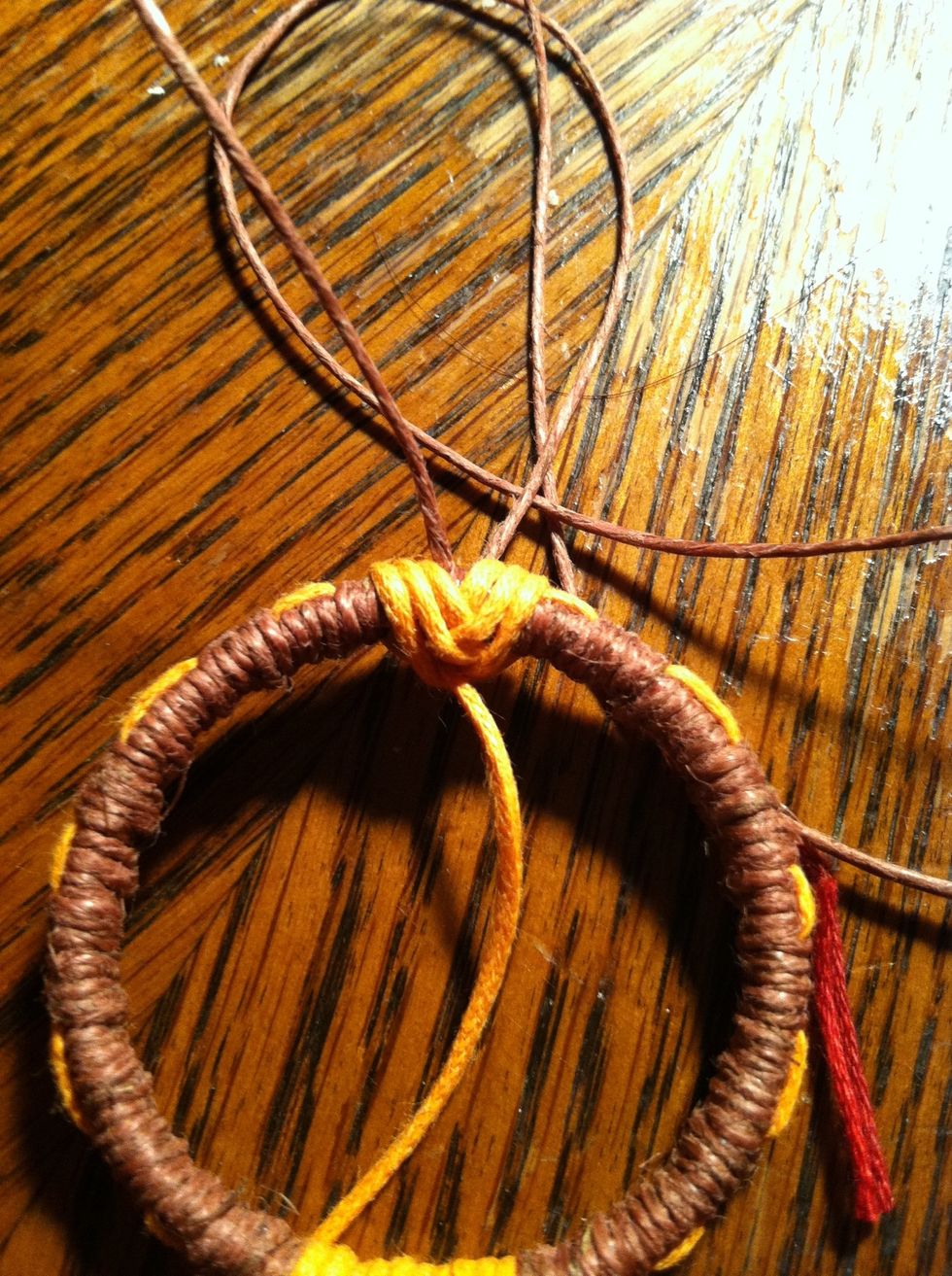 Carefully retighten and spread your string back to cover any gaps. It should now be facing downward. This will hold your center charm. You can add it now but I'm going to wait.