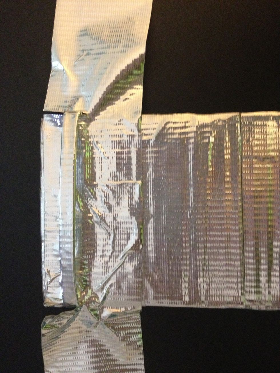 Carefully slide the piece of duct tape under the hook like is shown in the picture. This step is rather difficult.