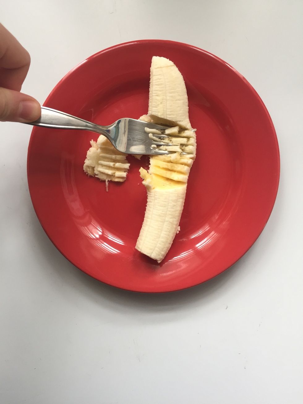 Carefully, start mashing the banana with a fork, until you reach a creamy consistence
