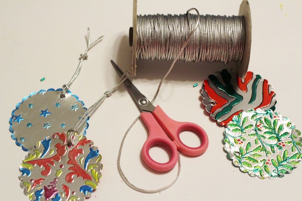 carefully tag tie cording for hanging. don't pull too tight or you will tear through the hole.