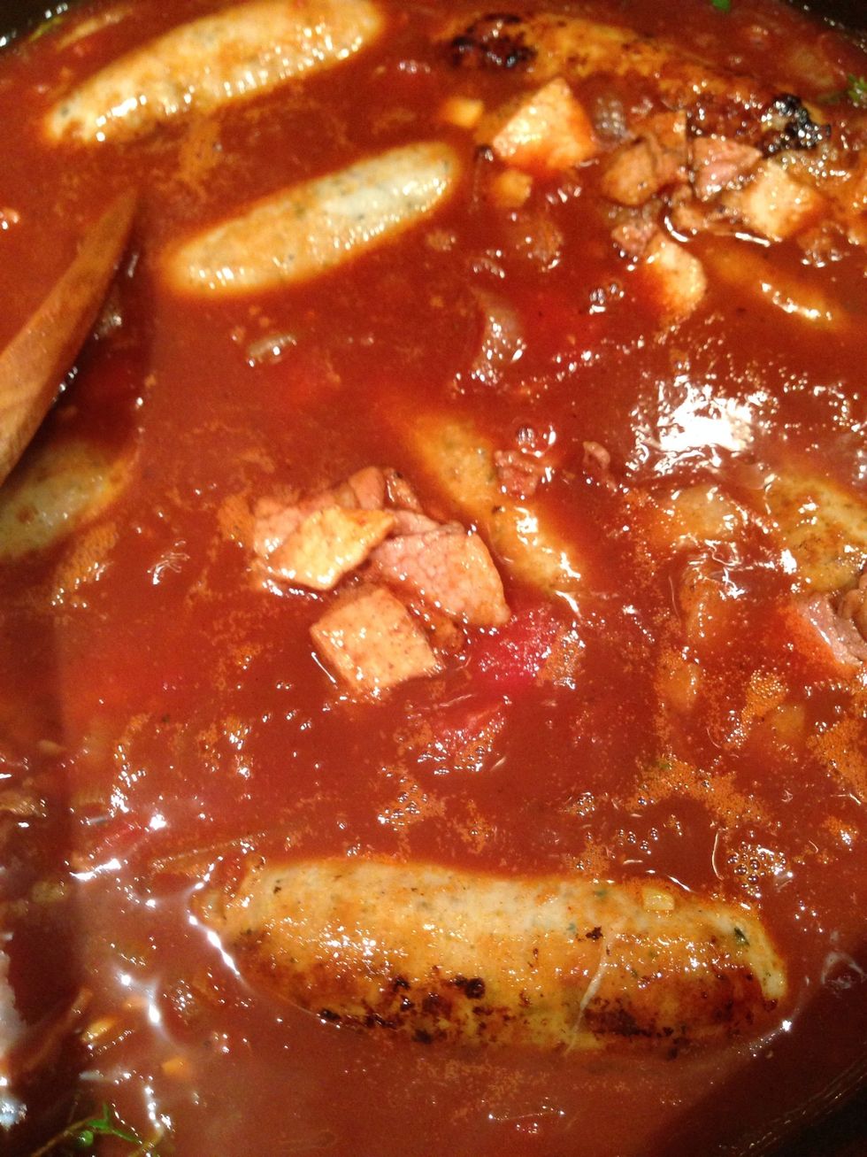 Carefully tip the sausages and bacon into the pan (with loose fitting lid) and cook on a medium heat for 30 minutes.