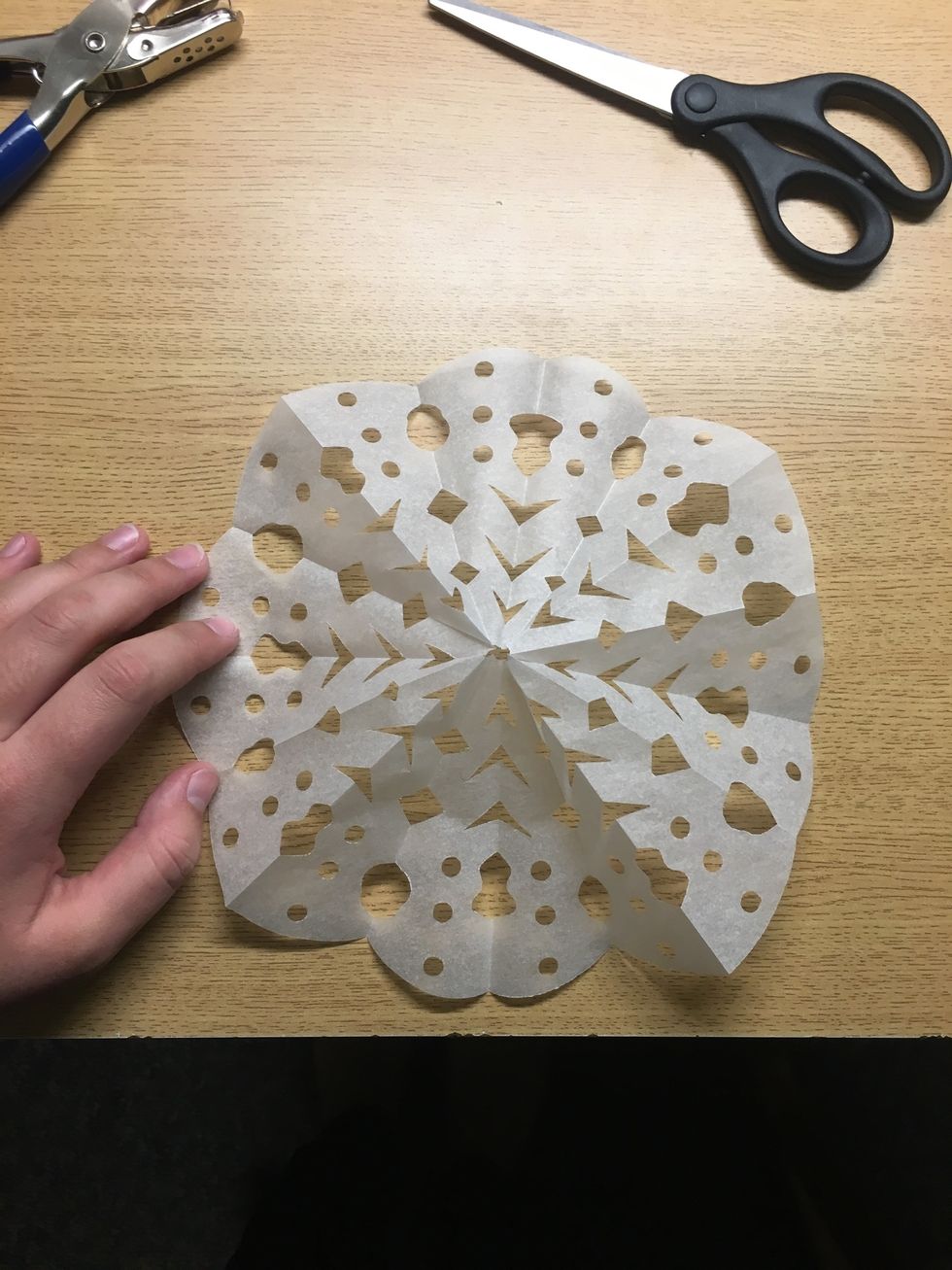 Carefully unfold, the tracing paper is a bit more resistant to being unfolded compared to printer paper. To make it lay flat go over each crease with a bone folder or a similar tool (or your nail).