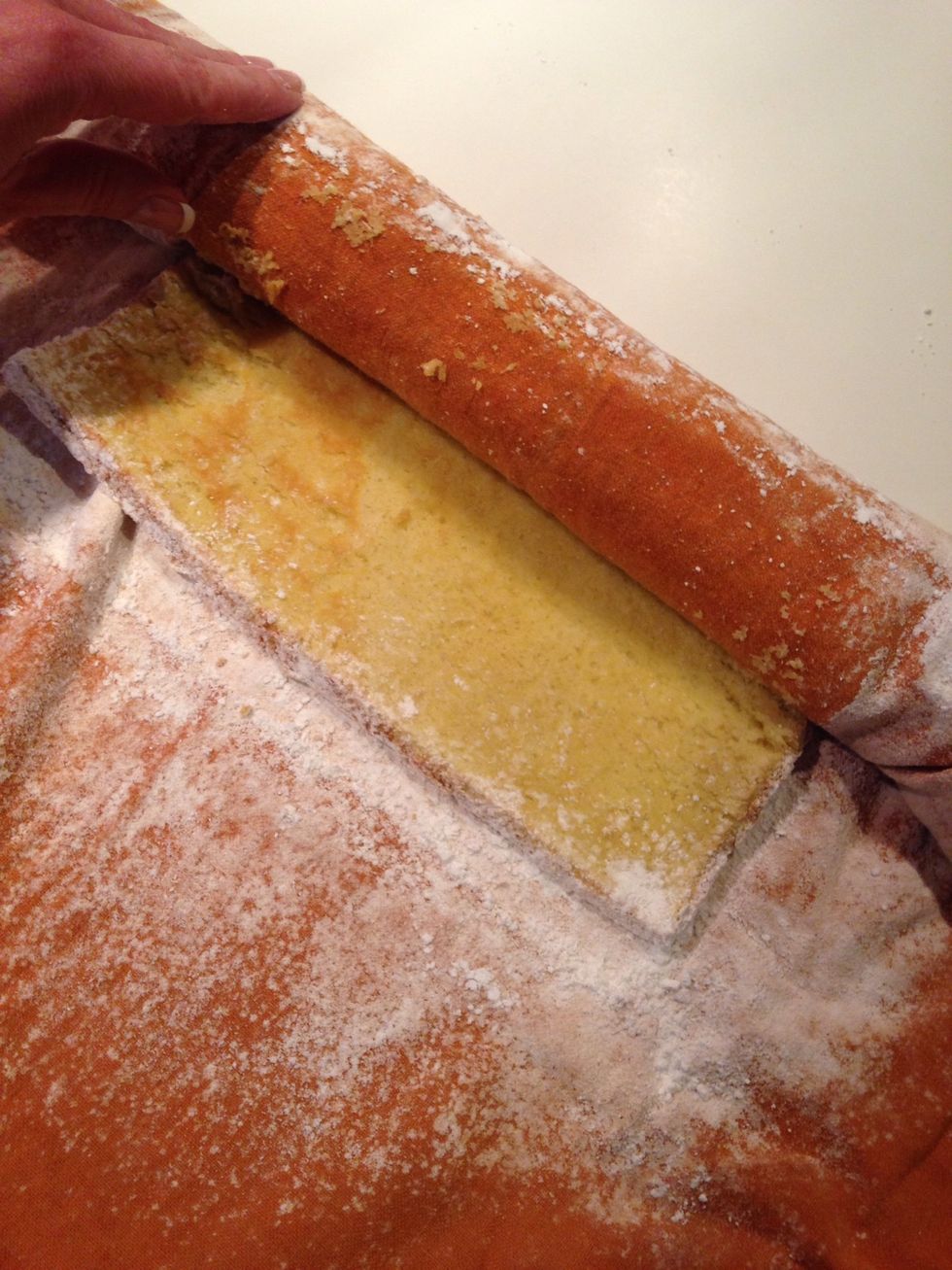 Carefully unroll and remove the towel. It is okay if some cake comes off on the towel.