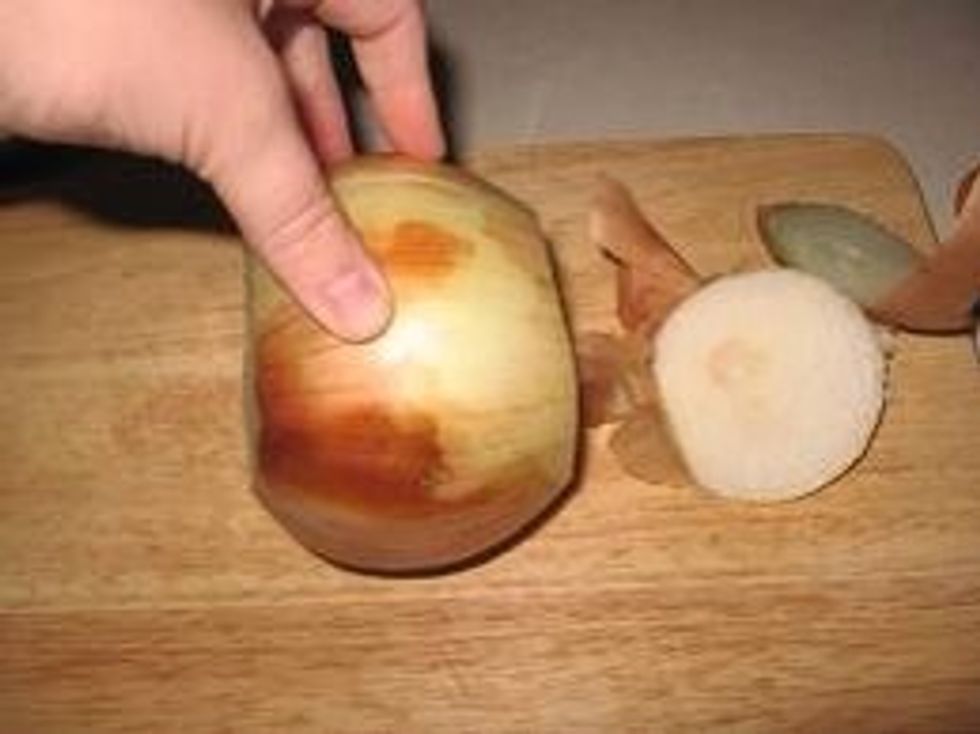 Carefully using cutting board and knife cut the top and bottom off the onion