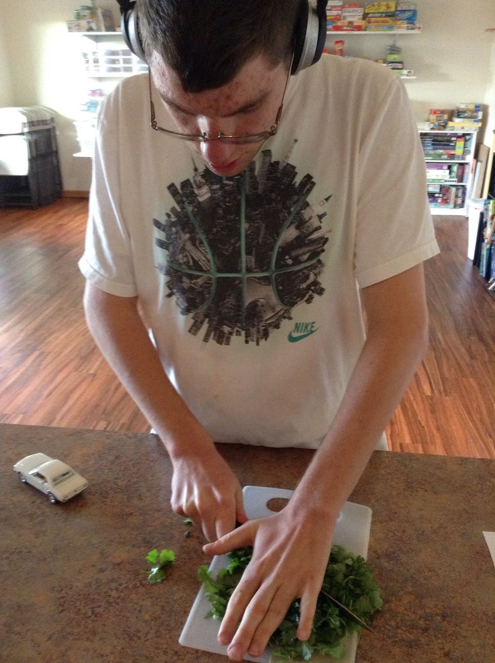 Carefully using cutting board finely chop cilantro
