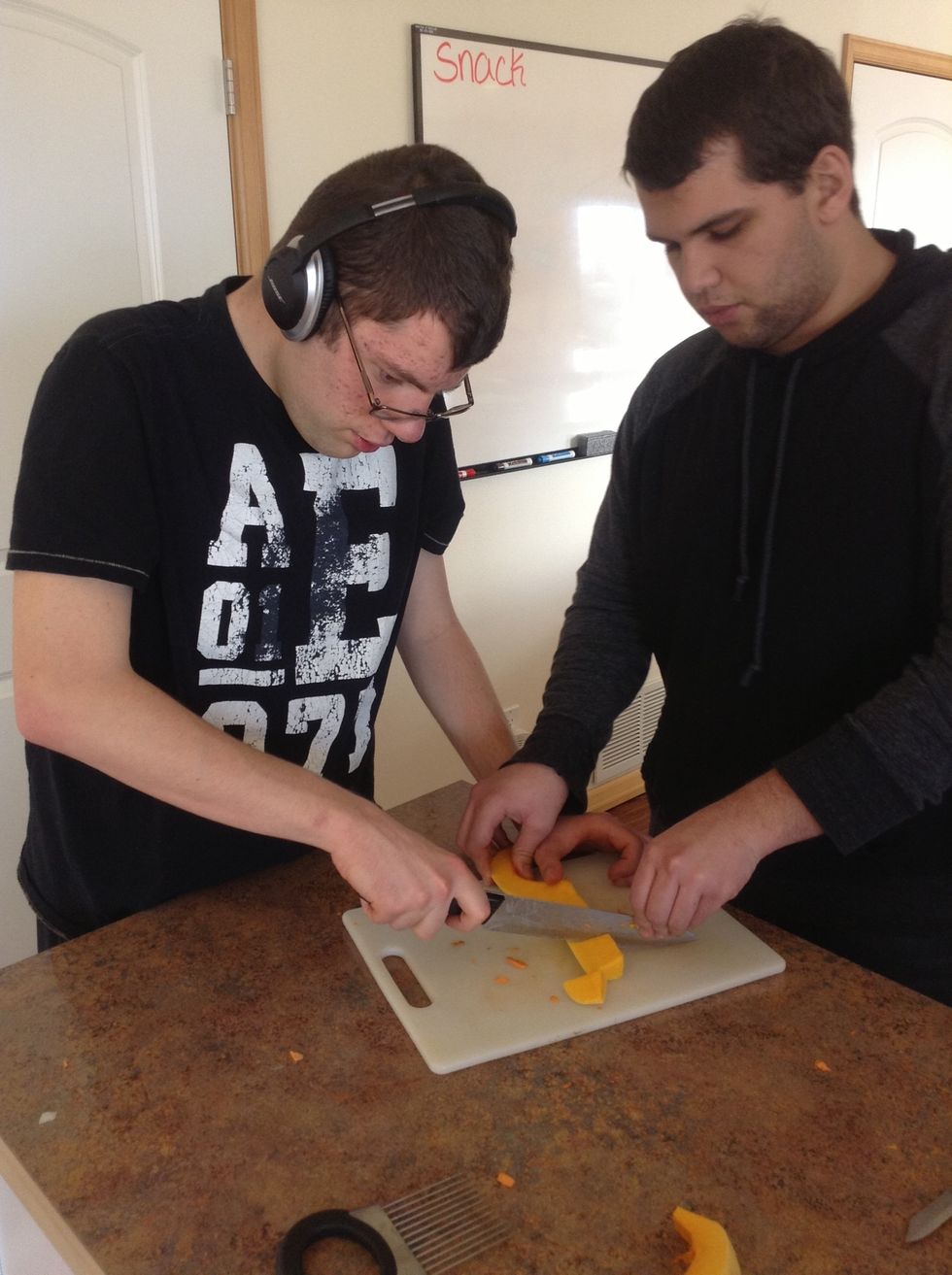 Carefully using knife and cutting board cut the butternut squash into small cubes. Keep knife tip pointed down to help cut through squash