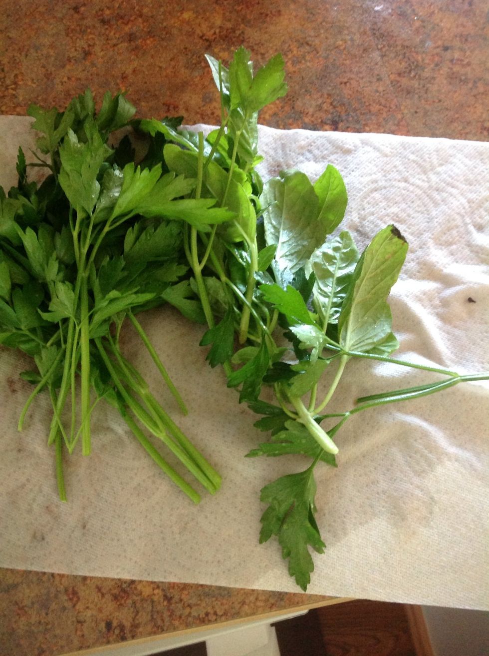 Carefully using knife and cutting board cut the herbs into small pieces.