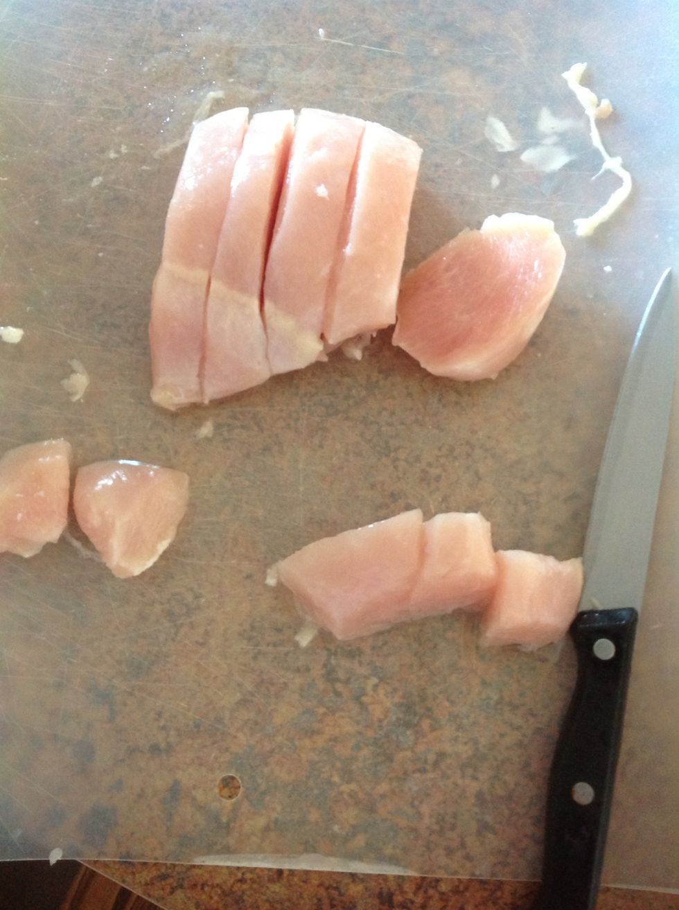 Carefully using knife slice chicken into small squares