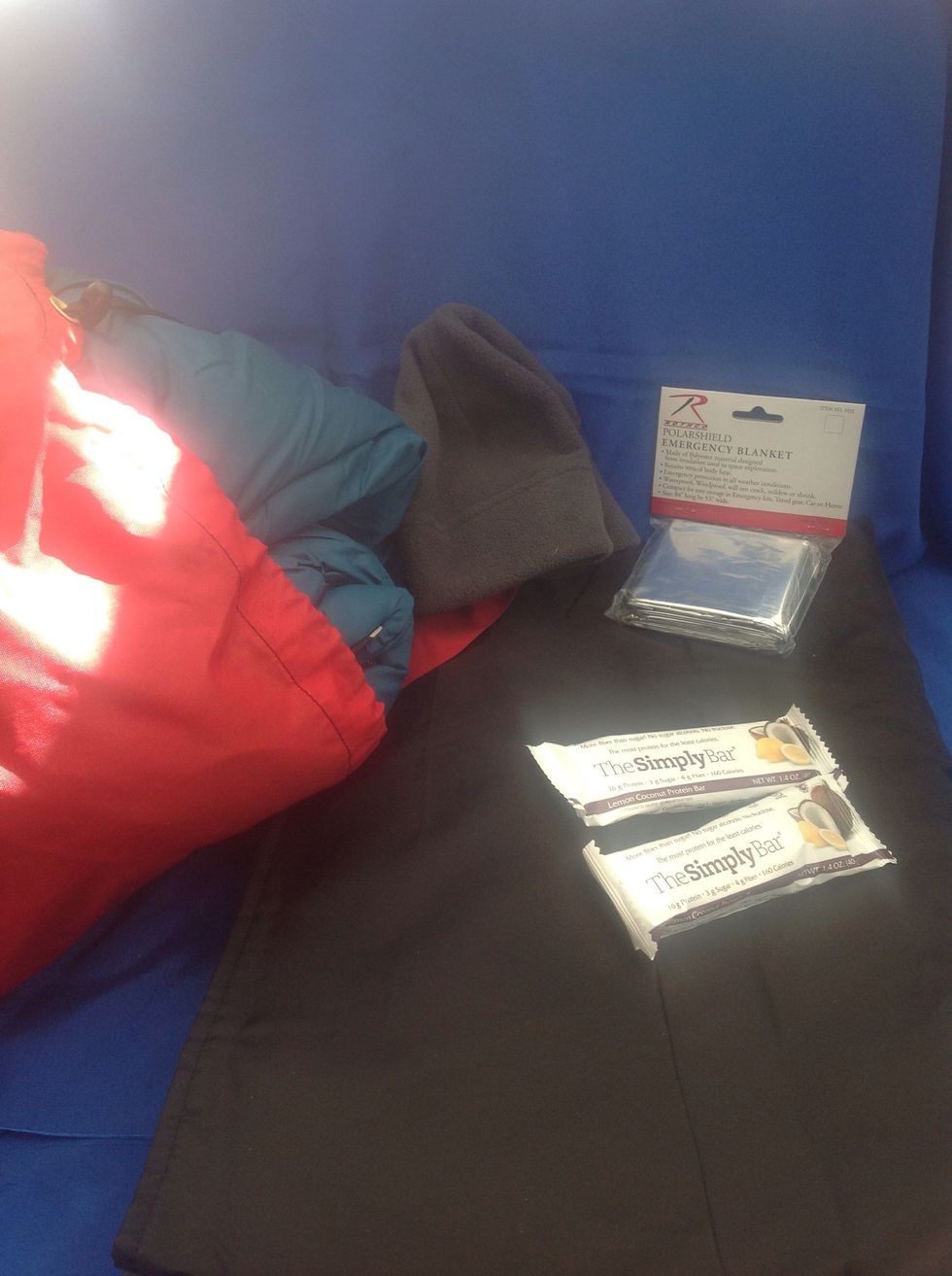 Carry a hat and blankets to keep warm. Our emergency kit has a sleeping bag, blanket, and emergency thermal blanket. Keep snack bars handy as well.