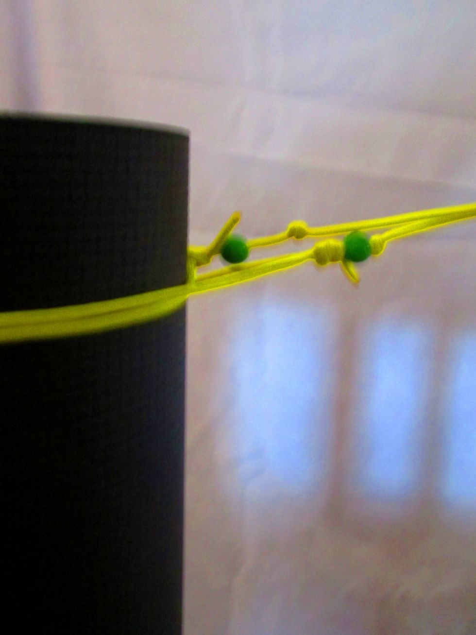 Carry On! Easiest\u2026.Open loops & put on one end of your mat together...tighten one & move down, tighten & go!!! To keep beads from sliding, w/ loops at their largest opening, tie a knot along cord.