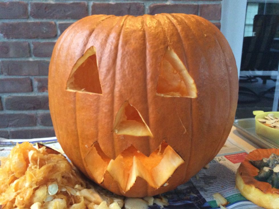 Carve scary mouth out with smaller knife.