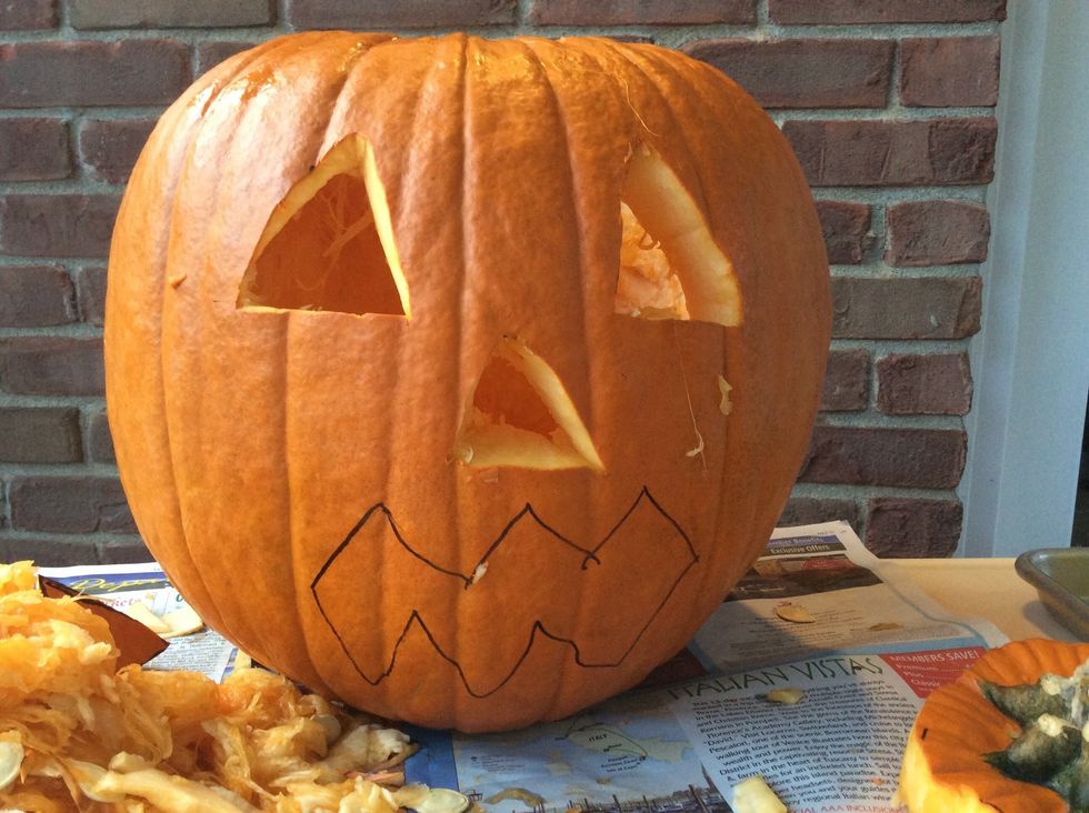 Carve the nose out with smaller knife.