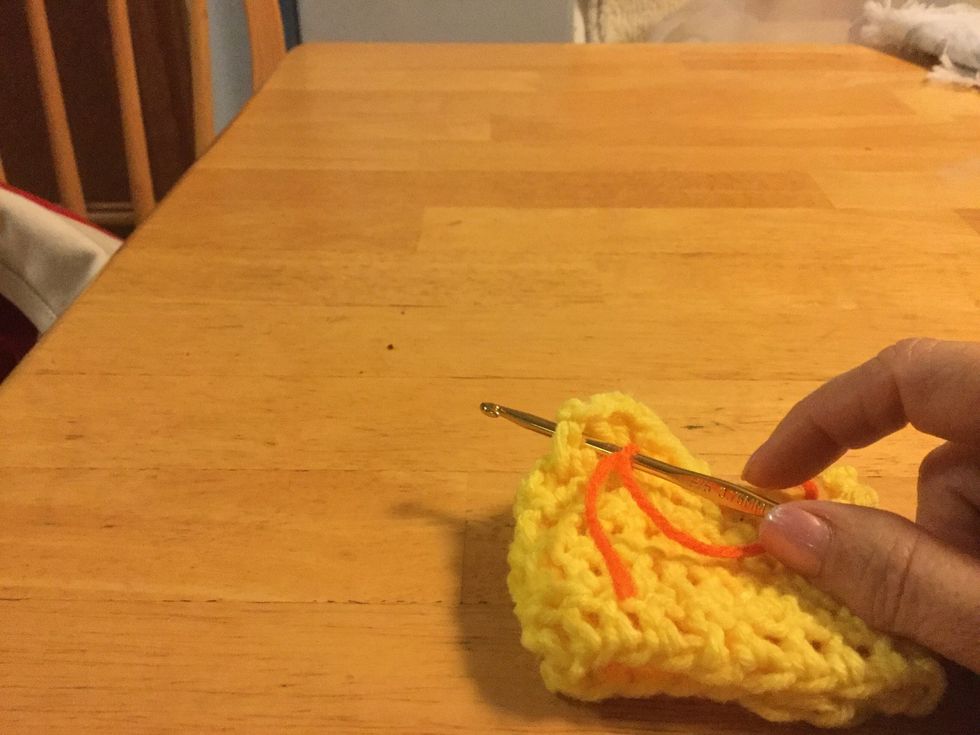 Catch yarn and slip stitch around the HDC post.