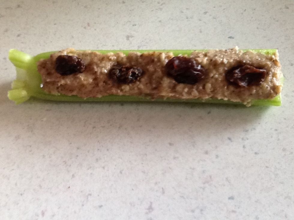 Celery, almond butter, and raisin snack.