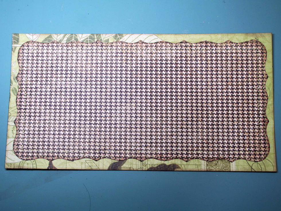 Center and adhere the houndstooth check over the green patterned paper.