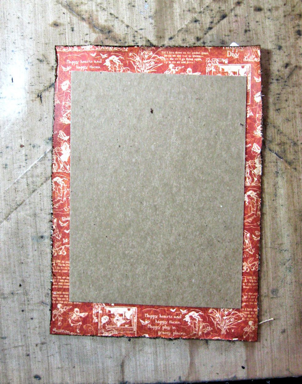 Center chipboard on the July paper panel. Glue in place. Now glue the prepared card front to the chipboard to create dimension. Glue the whole panel onto the prepared 5x7 brown card base.
