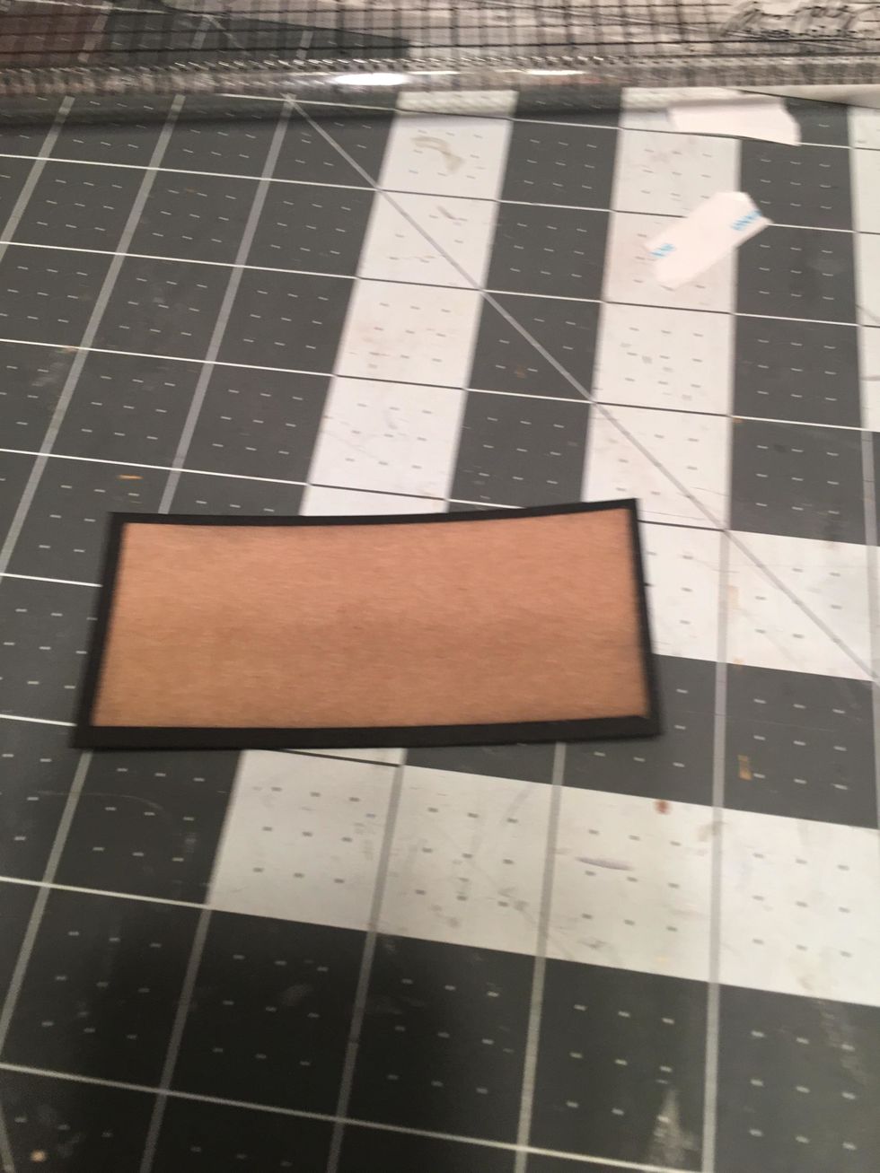 Center the kraft paper over the black cardstock as shown.