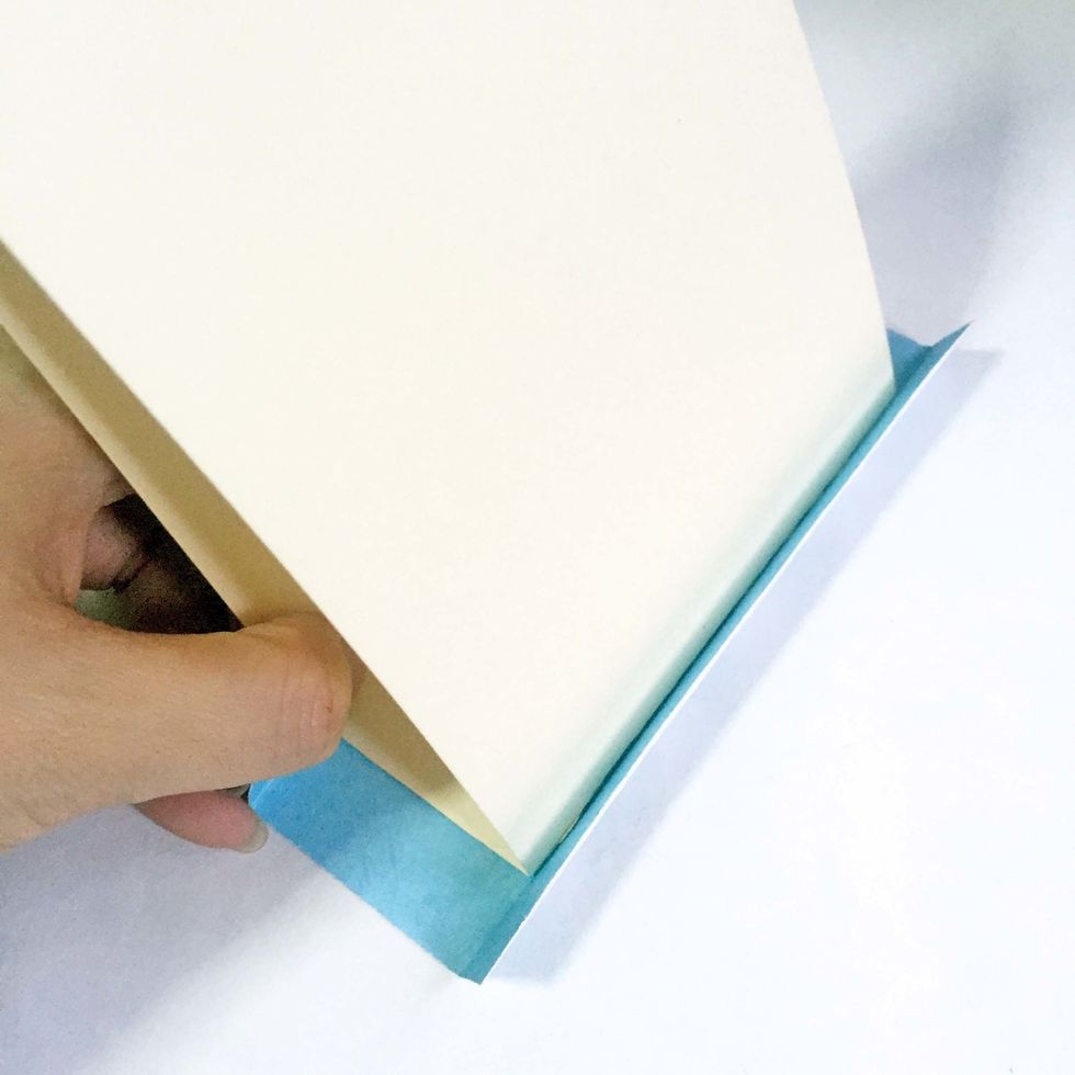 Centralize and glue down the base onto the pattern paper you've prepared in Step 8. Some space should be left on both ends of the tags. Adjust when necessary.