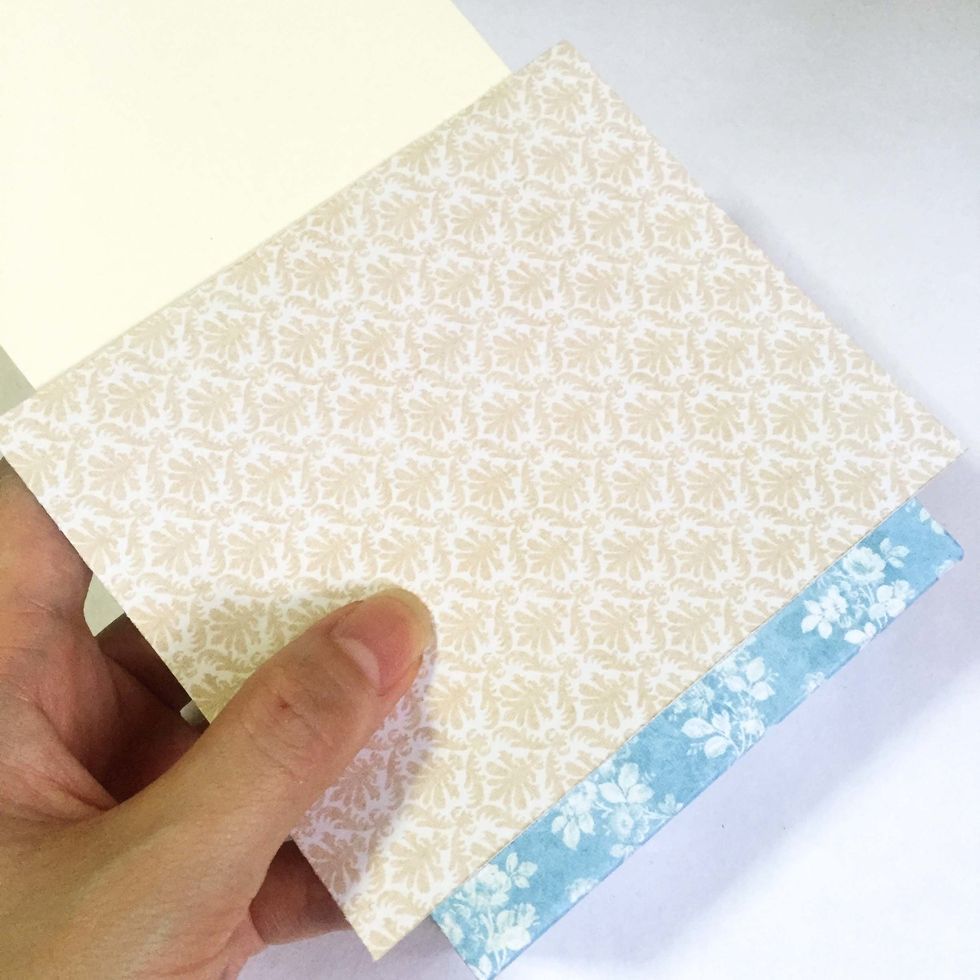 Centralize and glue down the pattern paper onto the exterior surface of the tag. Repeat on the other side.