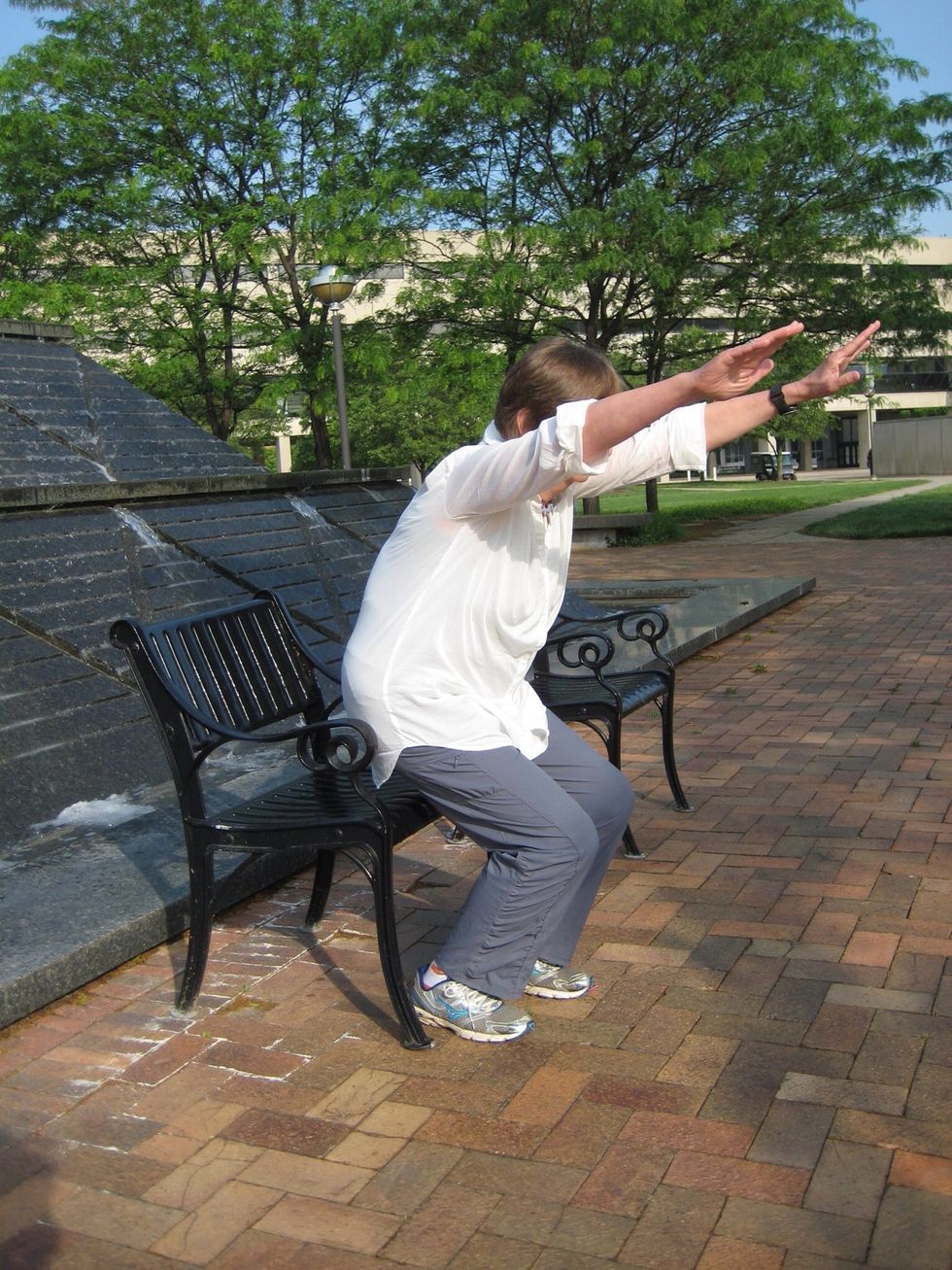 Chair pose \u2013 hands extended up and out in front shoulder width apart, lift hips off seat if possible