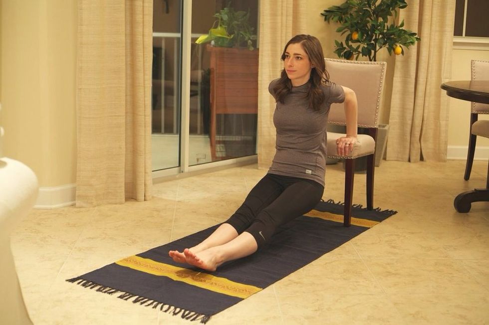 Chair-Ups: Start by sitting at the edge of your chair and place your hands on the edge with fingers folded over and legs out. Lower yourself so your elbows are at 90 degrees, then rise back up