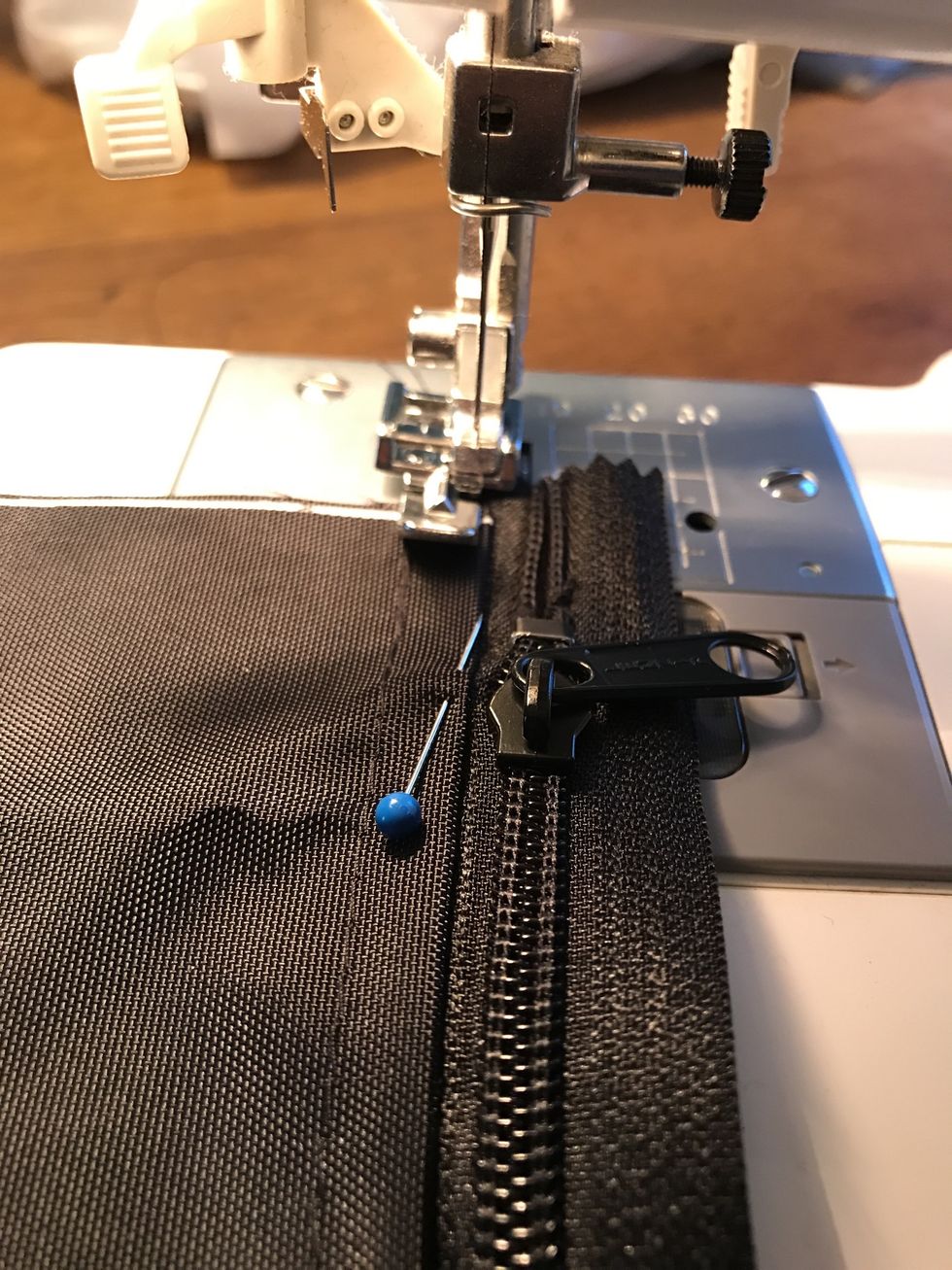 Change to the zipper foot "E" and stitch a straight line from M to N. be sure to backstitch at the top and bottom. Be very careful that you don't hit the zipper with your needle.