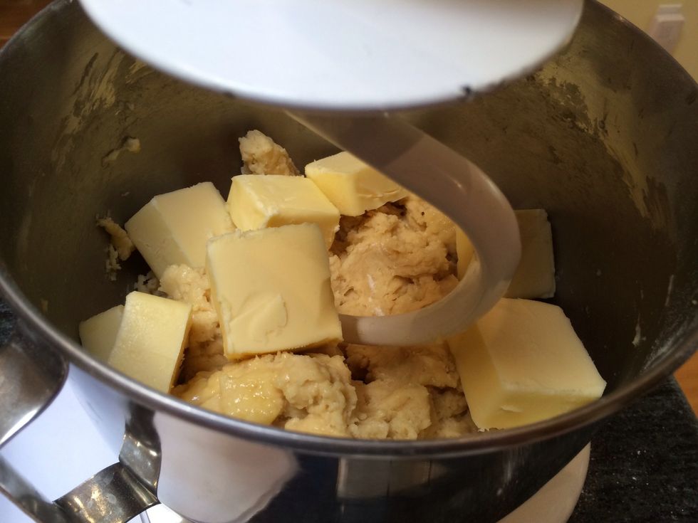 Change your mixer to the dough hook. Add the 2 sticks of butter you just cut, and beat on low speed until the flour mixture and butter are completely incorporated. This will take about 10 minutes.