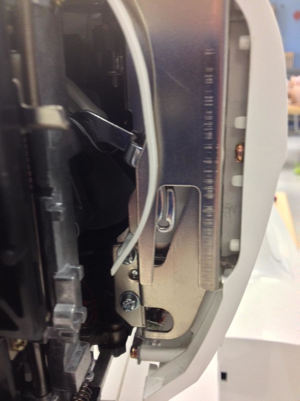 Check closely to see if any threads have been caught in the thread take-up lever. (Center)