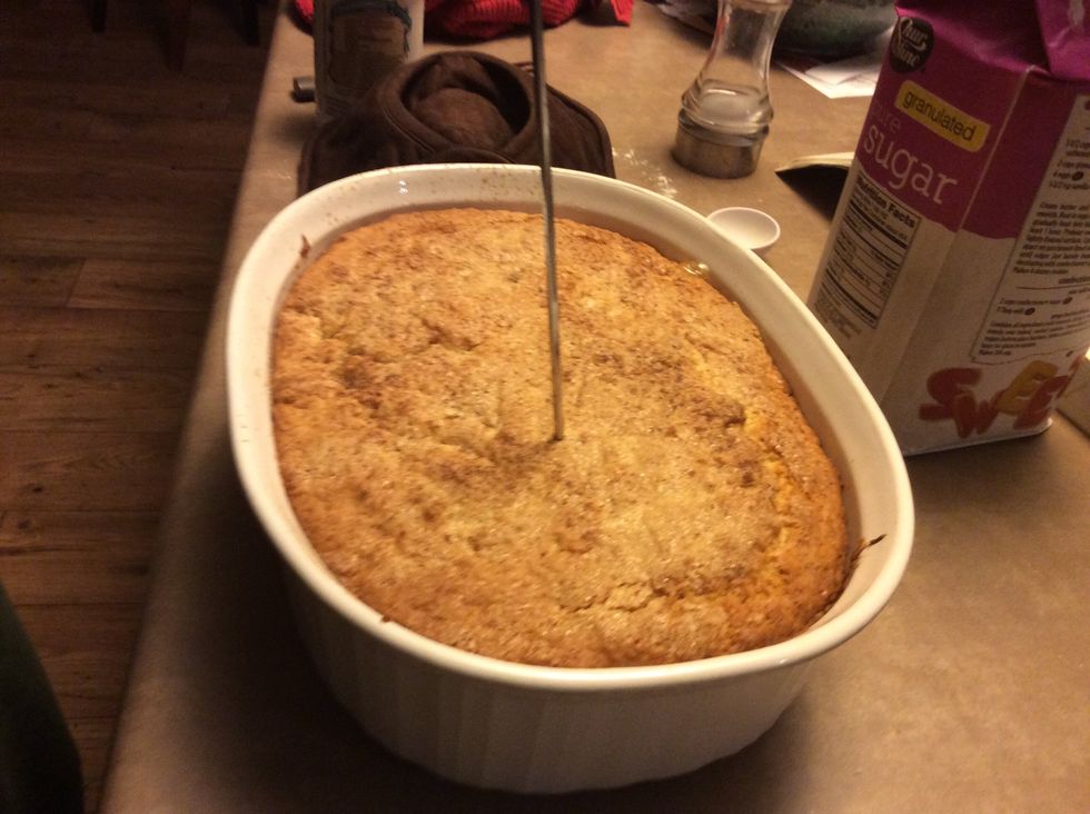 Check if the topping is cooked all the way through. To do that, stick a knife or a skewer into the topping and if it comes out with wet dough on it keep cooking.