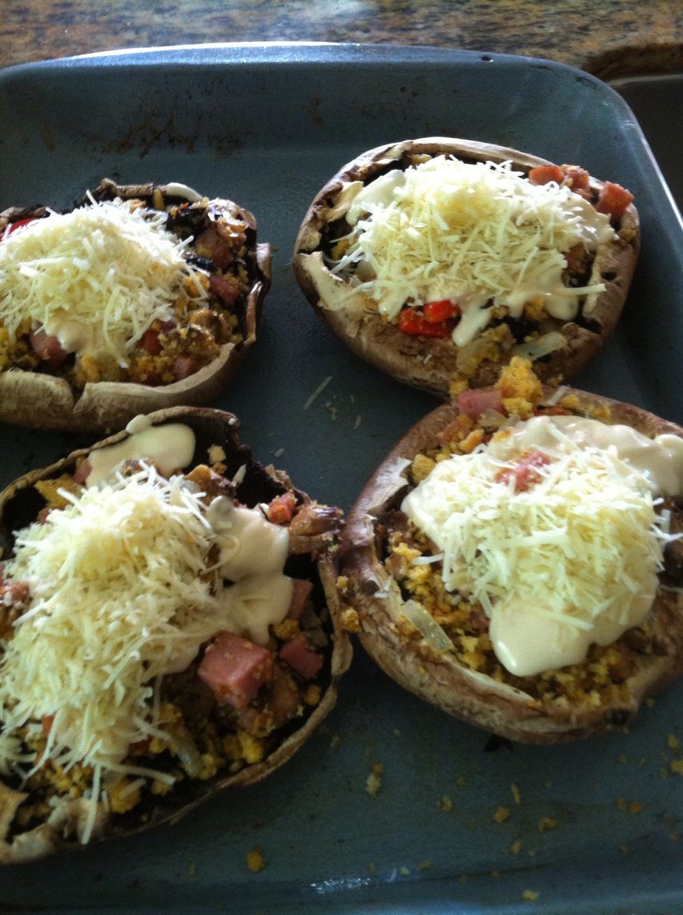 cheese cheese cheese... then set the oven 350  and cook for 15 mts until the mushroom texture is soft ... no cause the cheese melt are done...be sure are easy to cut with a fork