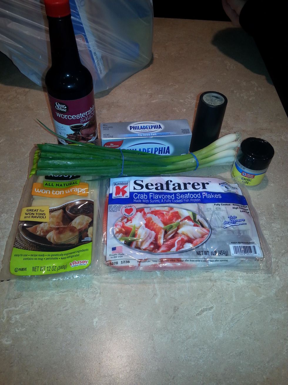 *cheese, softened *garlic salt *Worcestershire sauce *black pepper *lump crabmeat, drained (or imitation crab) *green onion, *wonton wrappers