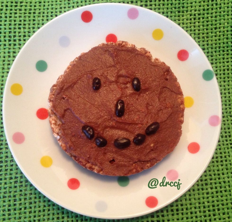 Chestnut butter mixed with raw cocoa powder and raw organic honey served atop a chocolate rice cake with cocoa nibs.