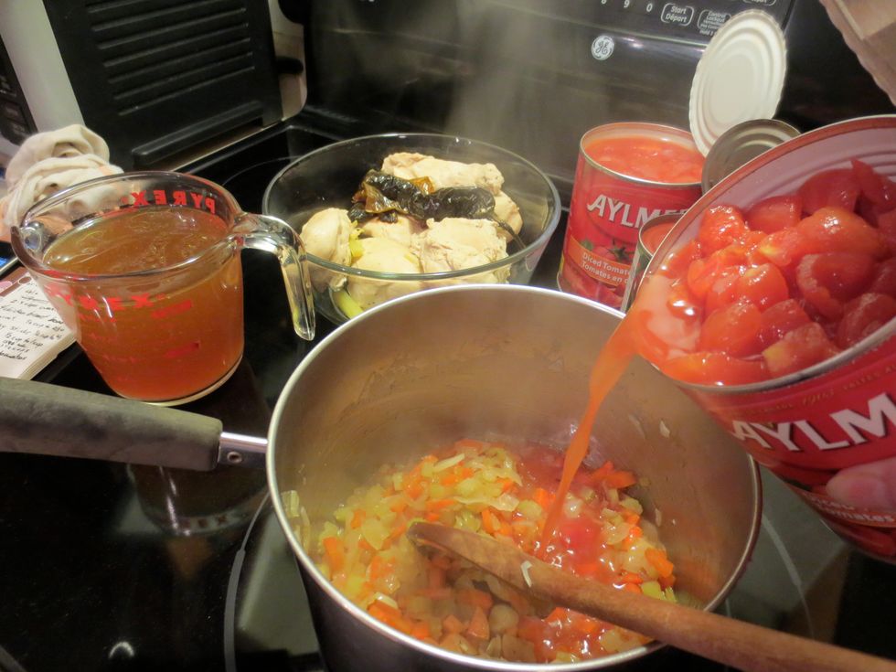 Chicken is done! Use tongs and put chicken in a large bowl, reserve the chicken broth. Veggies are done, open up your tomatoes and add them to the pot. Cook tomato/veg for another 10 to 15 minutes.