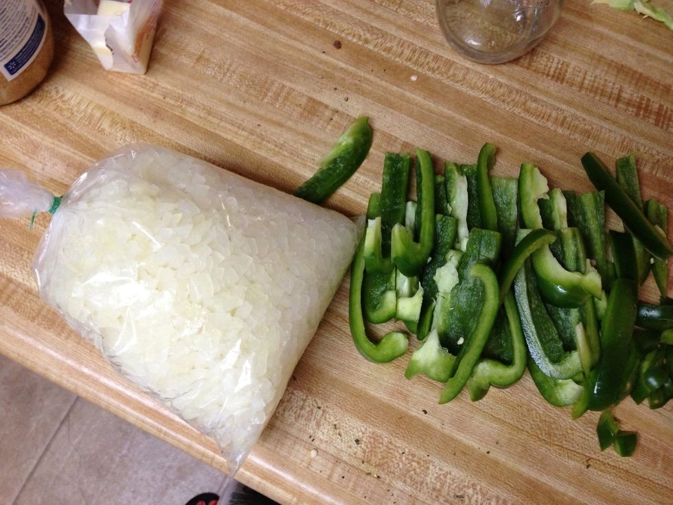 CHICKEN PHILLY CHEESE STEAK slice onions and peppers.