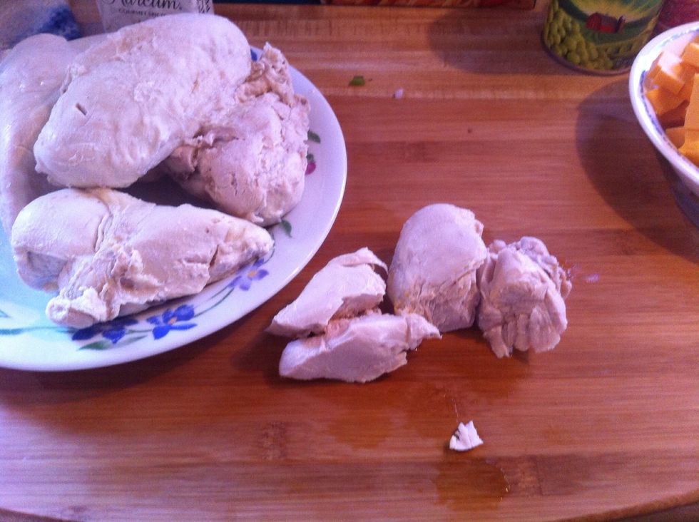 Chicken should be done by now. Save about 5 cups of the broth in the pot you boiled the chicken in add about 5 chicken bouillon cubes. Cut largest piece chicken in half to ensure it is not pink at all