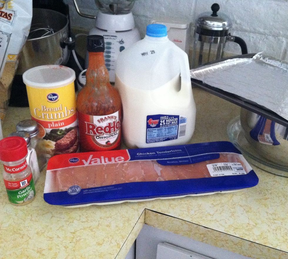 Chicken tenderloins, franks, milk, bread crumbs, salt, pepper, garlic powder, large mixing bowl, cookie sheet, pie pan.