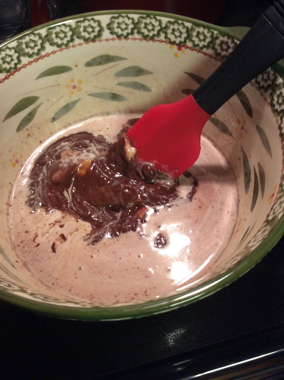 Chocolate chips, peanut butter, and heavy whipping cream being mixed together.