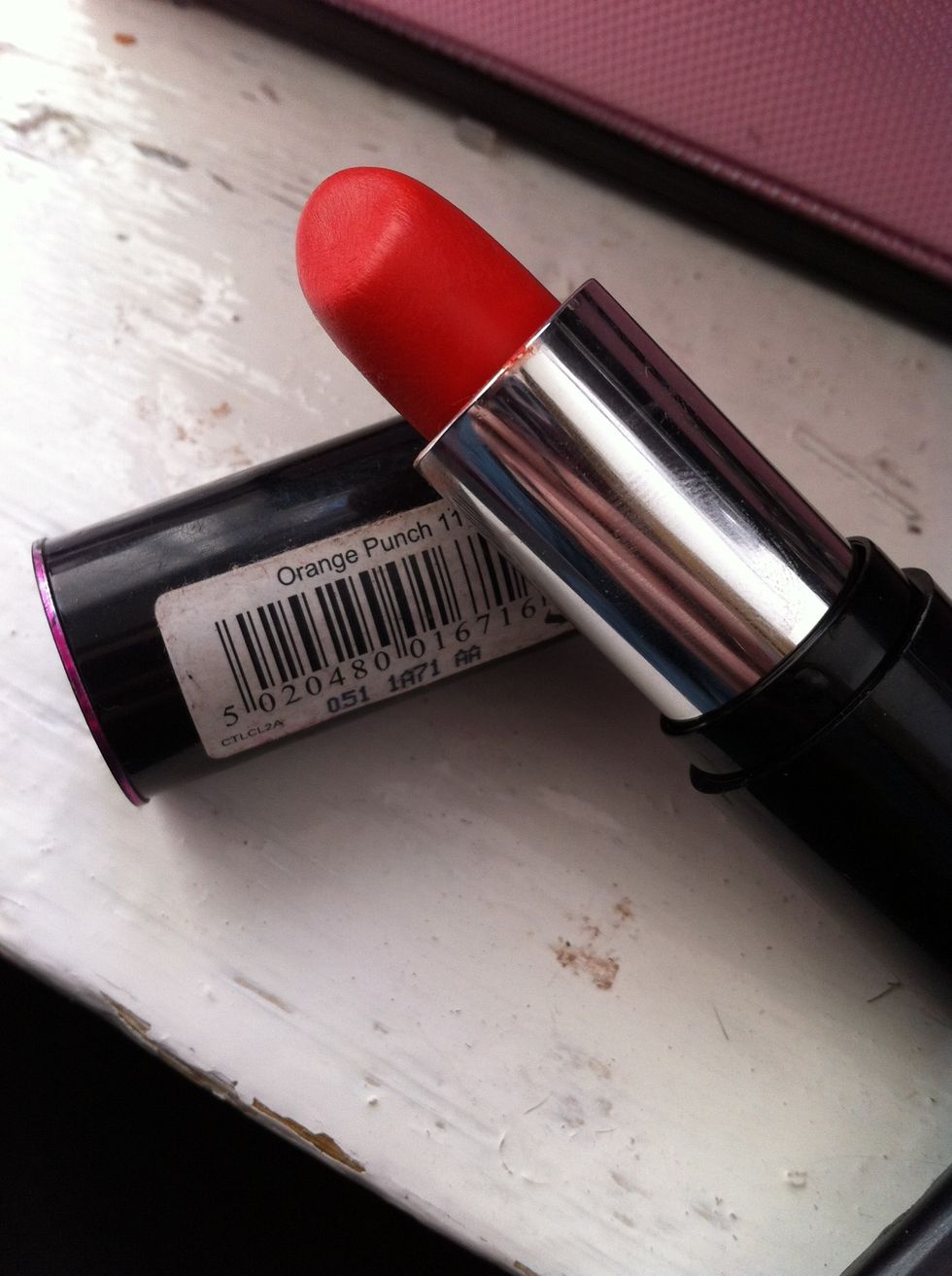Choose a lighter/brighter lipstick, this is 'Orange Punch' by Collection 2000