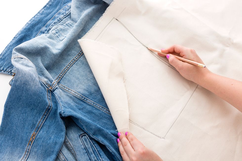 Choose a panel on your denim jacket that is surrounded by a \u201cborder\u201d of seams and lay your canvas fabric on top of it. Trace the shape of your panel with a pencil.