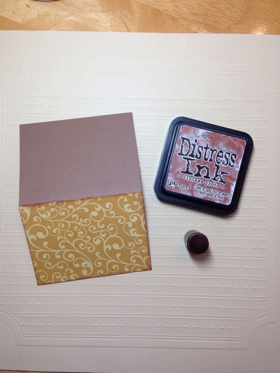 Choose a pattern paper to use as your background and cut a 3x4 inch piece. Ink the edges with brown ink and adhere to the front of your card.