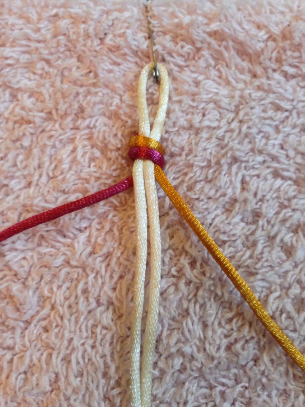 Choose colours and how many you want up to 4 and tie off. Then pin down to something weighted. Take one thread LEFT, 2 threads in the MIDDLE (the core), and one thread to the RIGHT.