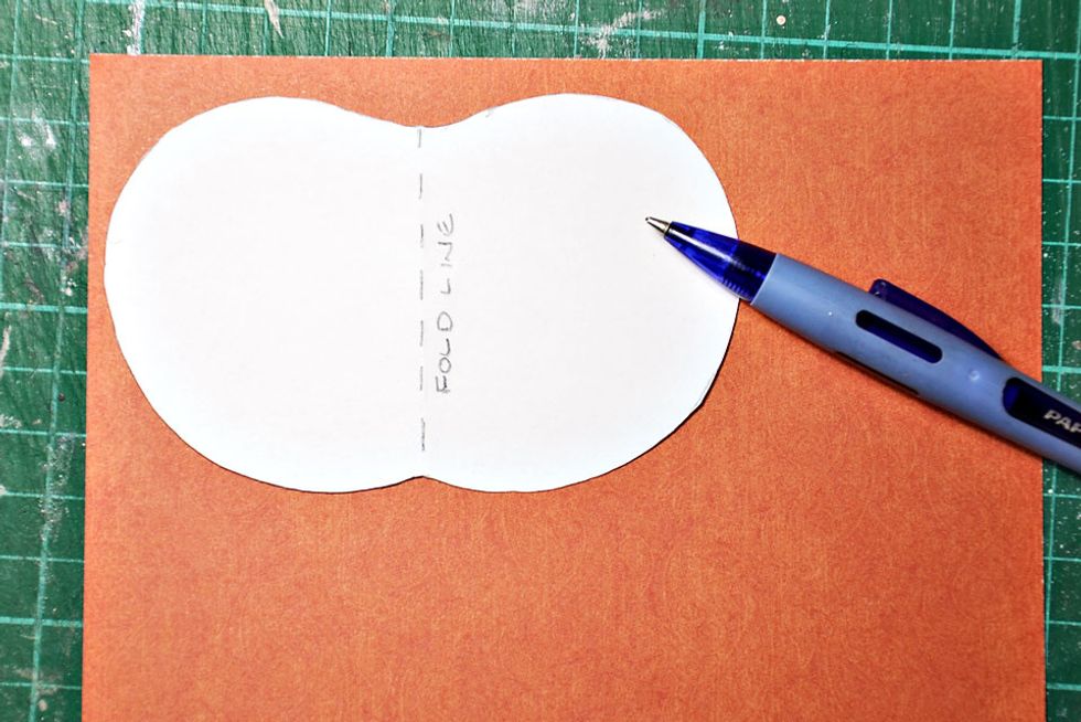 Choose the patterned papers of your choice and start tracing around the template. I have traced about 24 pumpkins for my pumpkin creation. The fuller you want the pumpkin the more you need to trace.