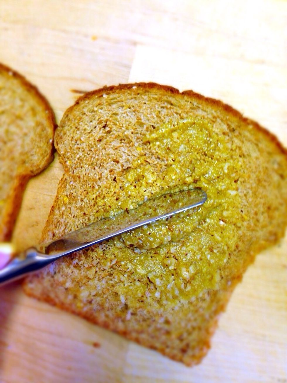 Choose two slices of your favorite bread (dark bread will work better with the nutty flavor). Spread thin layer of nutty spread on both slices of bread